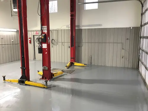 Fresh painted walls and epoxy flooring of a mechanic shop in Cochrane, Alberta.